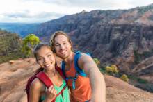 A couple hiking near the rental they found while searching for where to stay in Kauai.