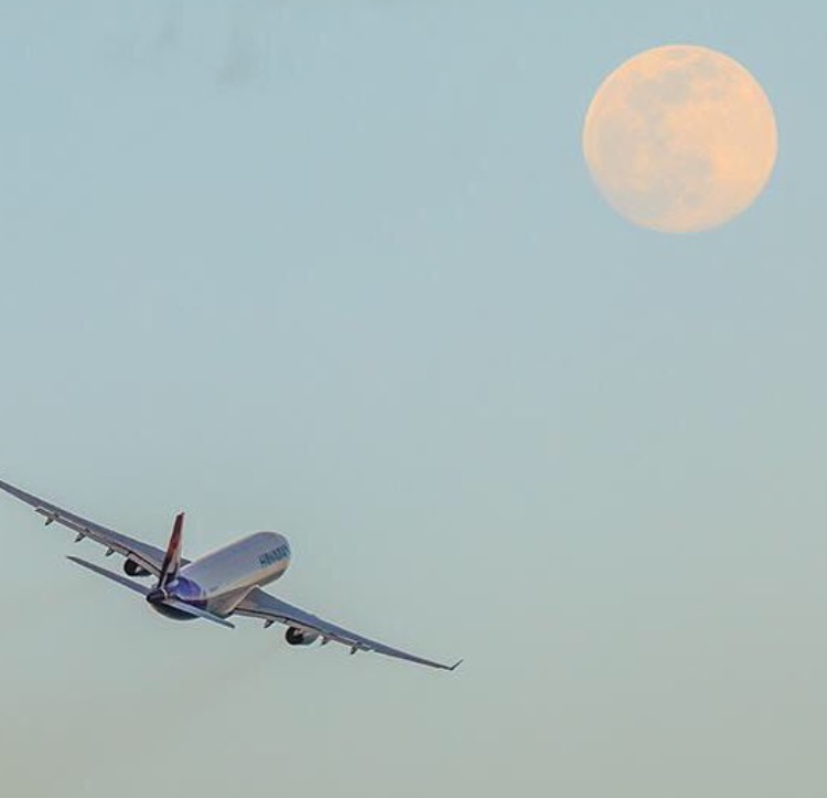 Airplane flying into moon